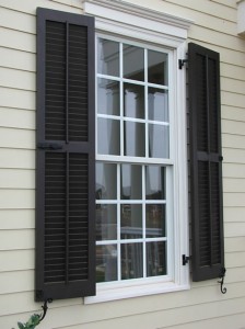 Exterior shutters with decorative iron hardware