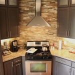 Painted cabinetry and cut stone backsplash